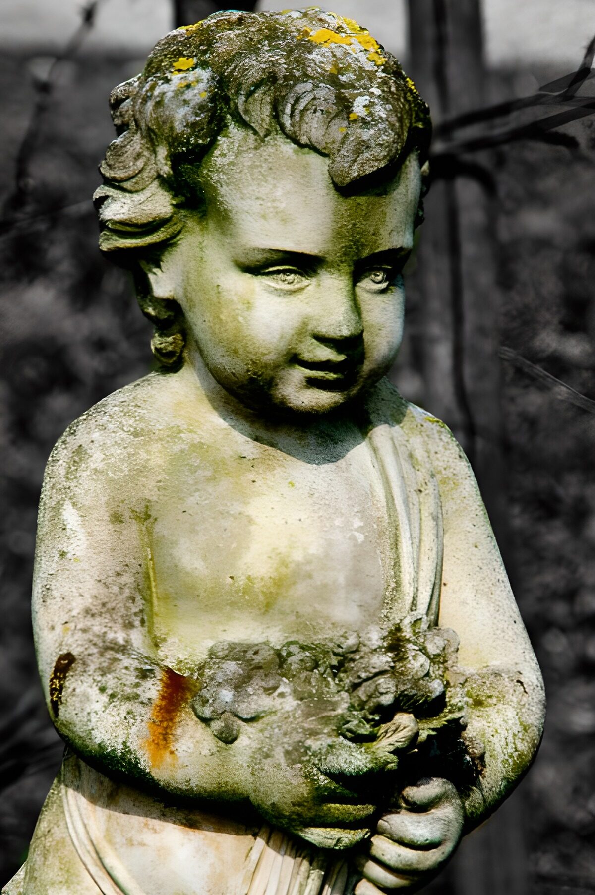 Weathered stone child holding flowers