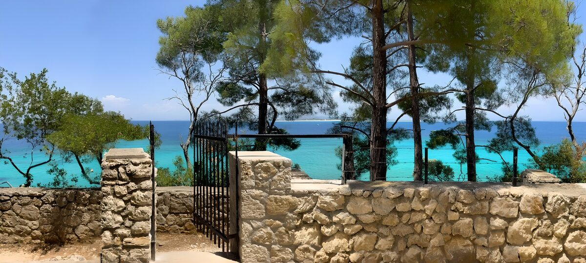 Open gate to a sunlit turquoise sea