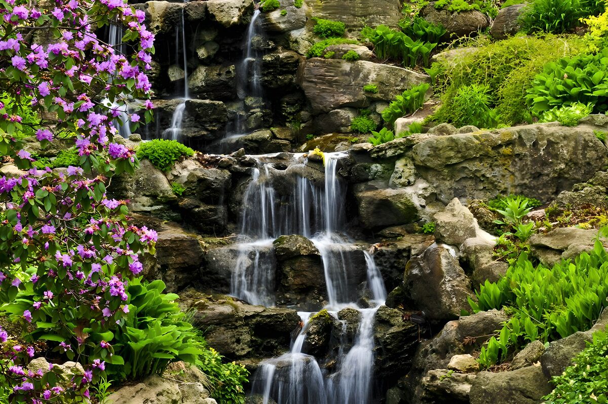 Garden waterfall with purple-pink blooms