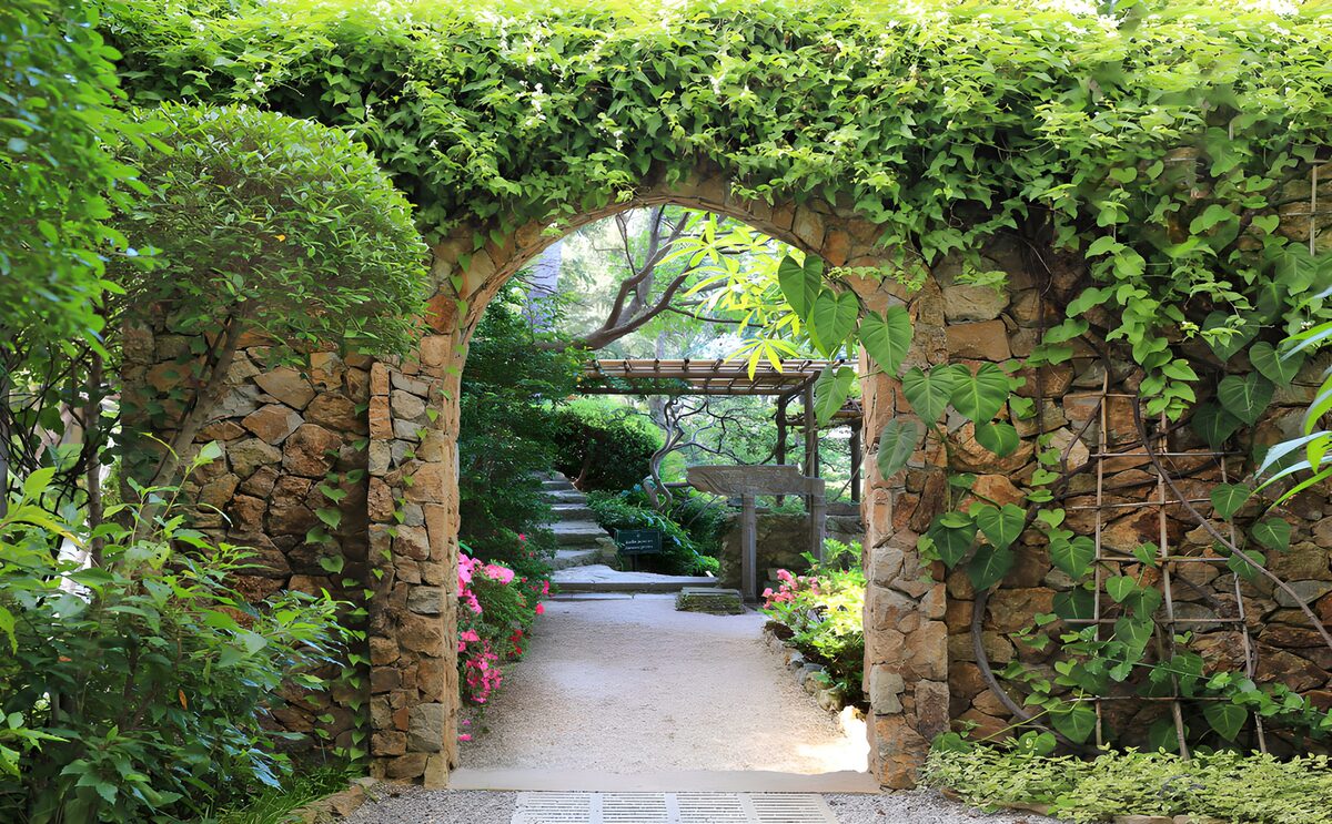 Stone arch and a sun-dappled garden path