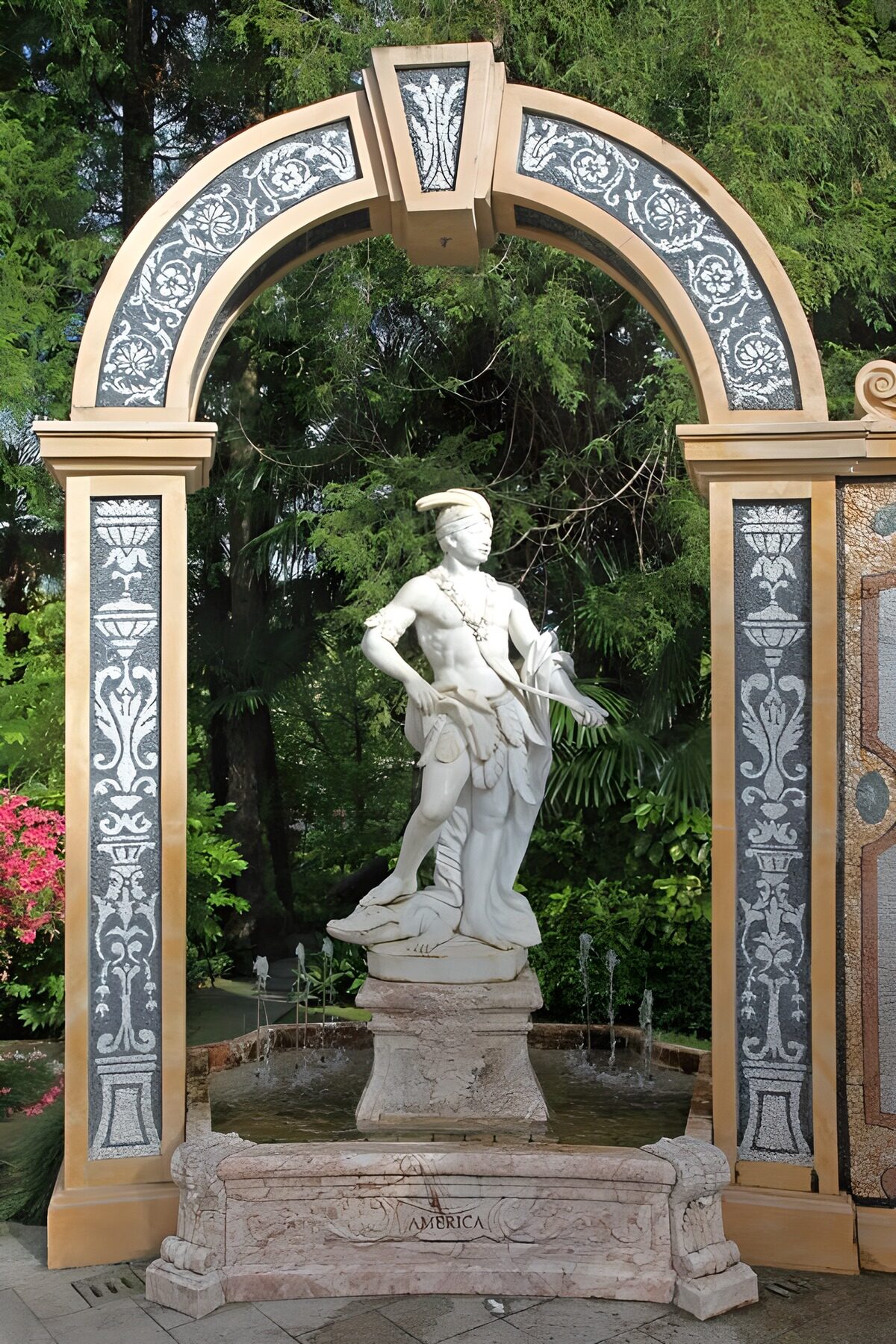 Sunlit statue beneath an ornate arch