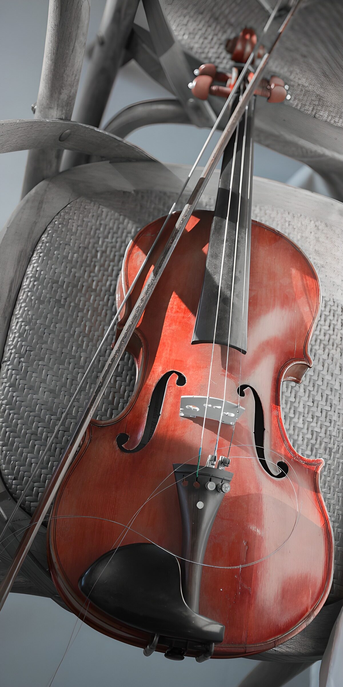 Warm wooden violin on a woven chair