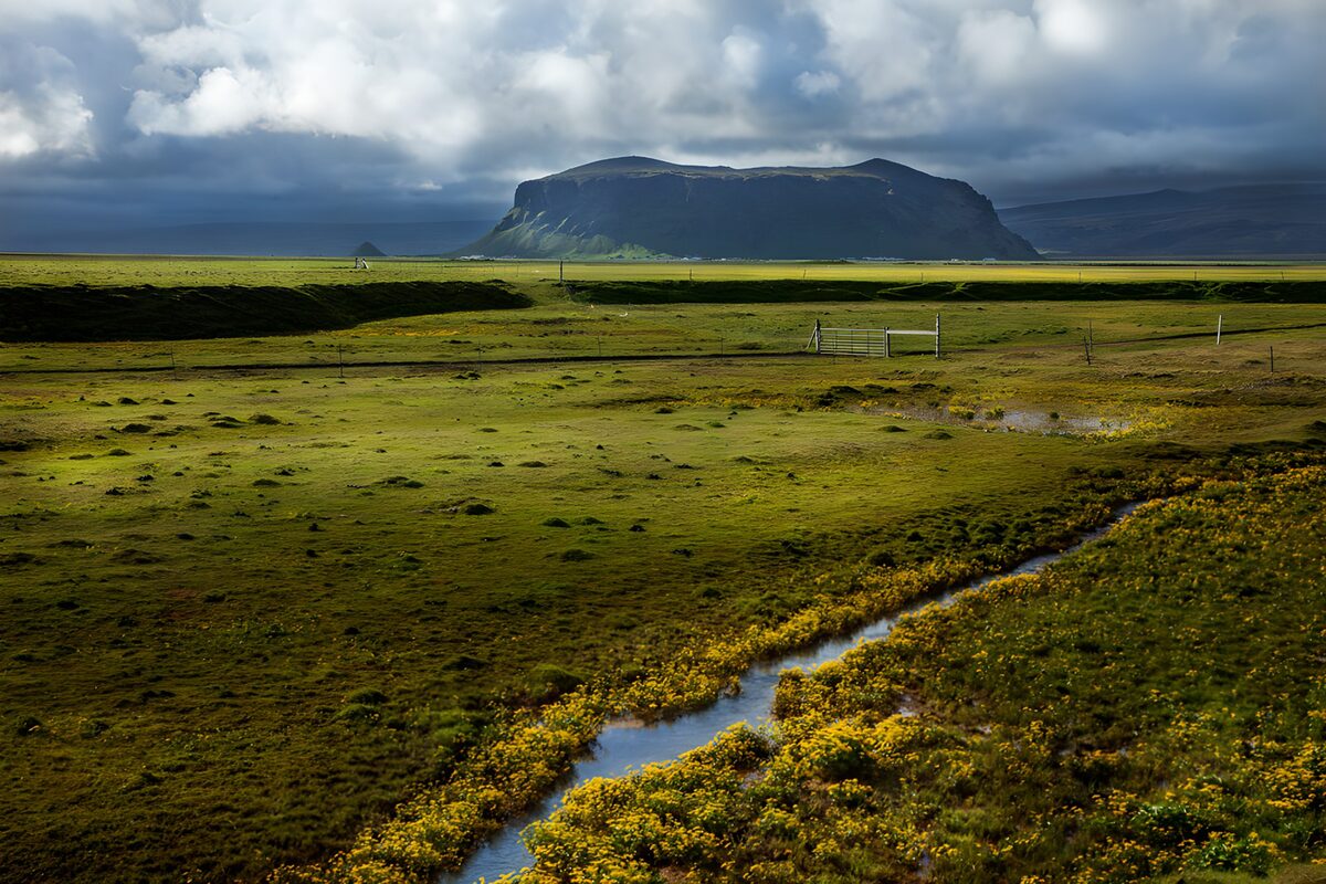 Winding stream beneath a flat-topped hill