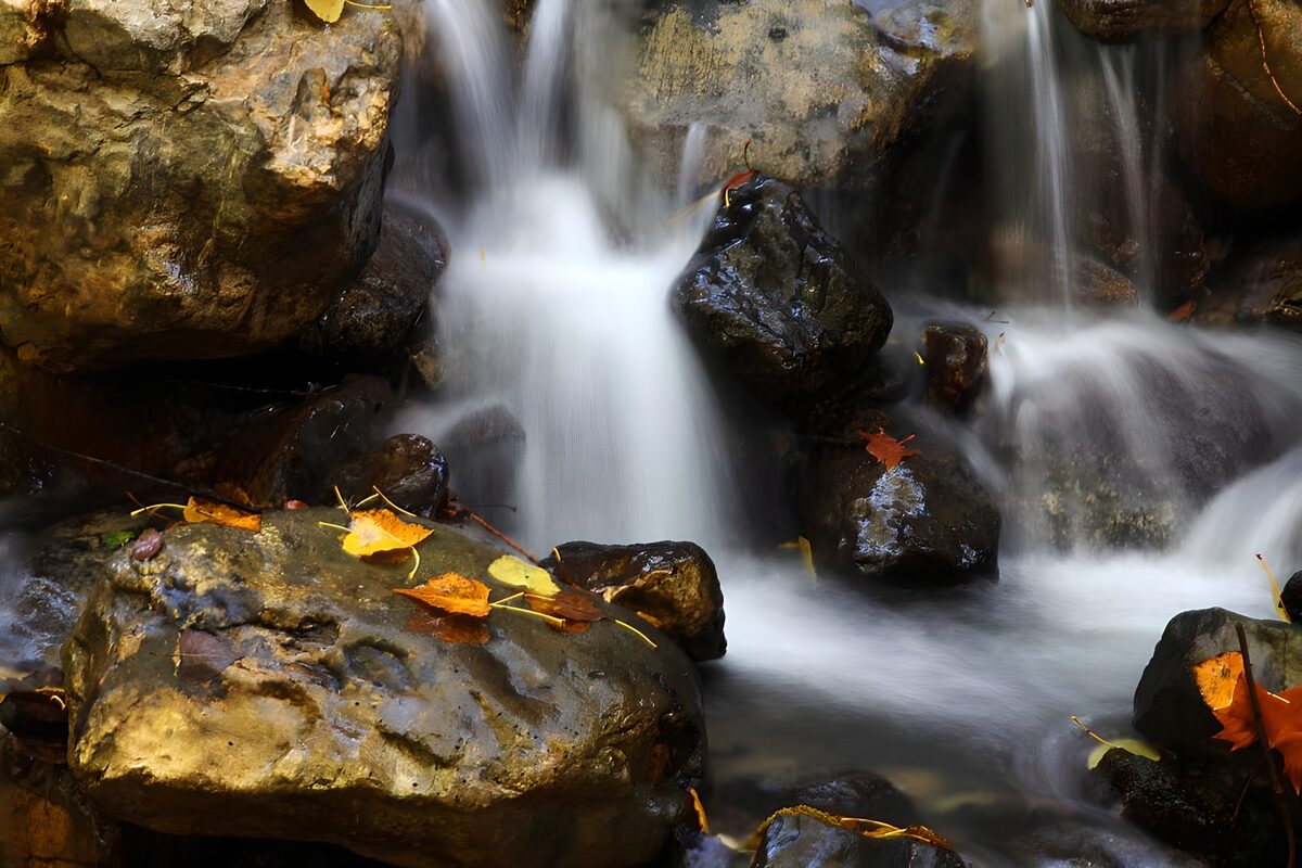 Autumn waterfall over glistening rocks