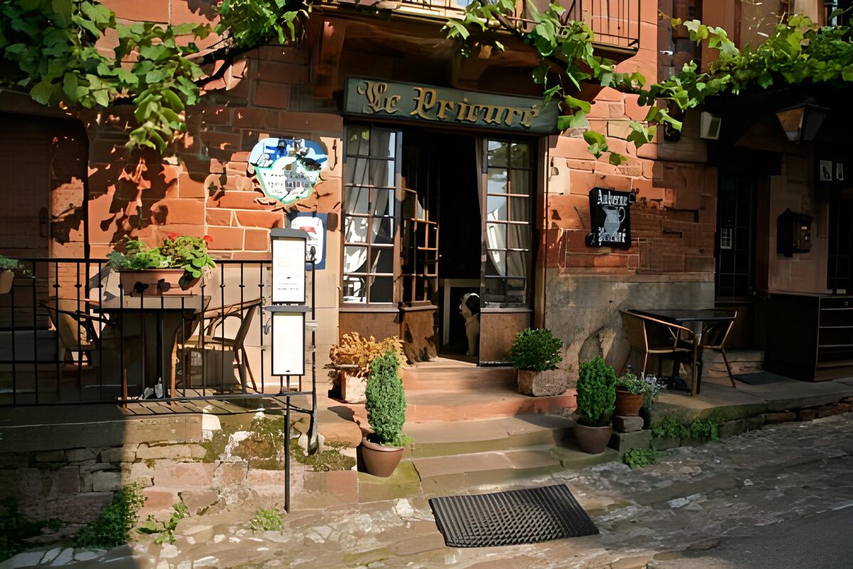 Sunlit restaurant steps and flowerpots