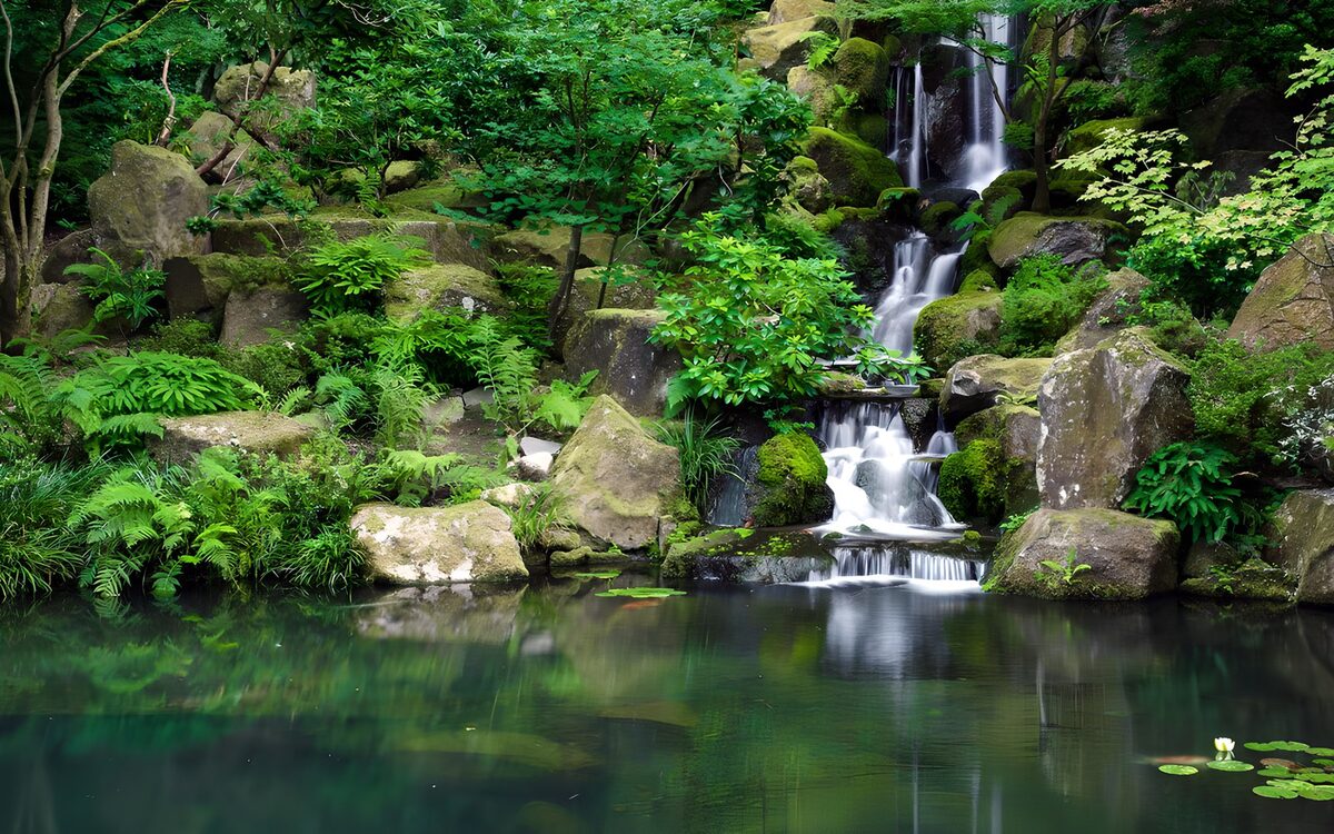 Tiered waterfall in a leafy rock garden