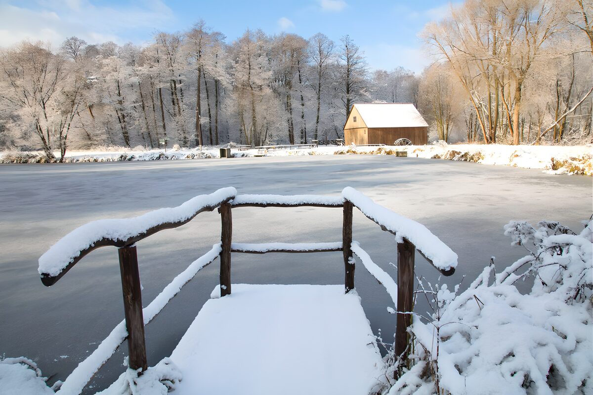 Snowy platform beside a frozen pond