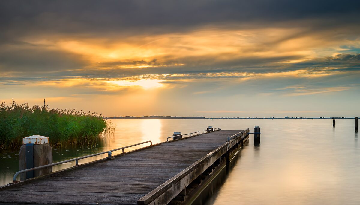 Wooden jetty on a lake at sunset