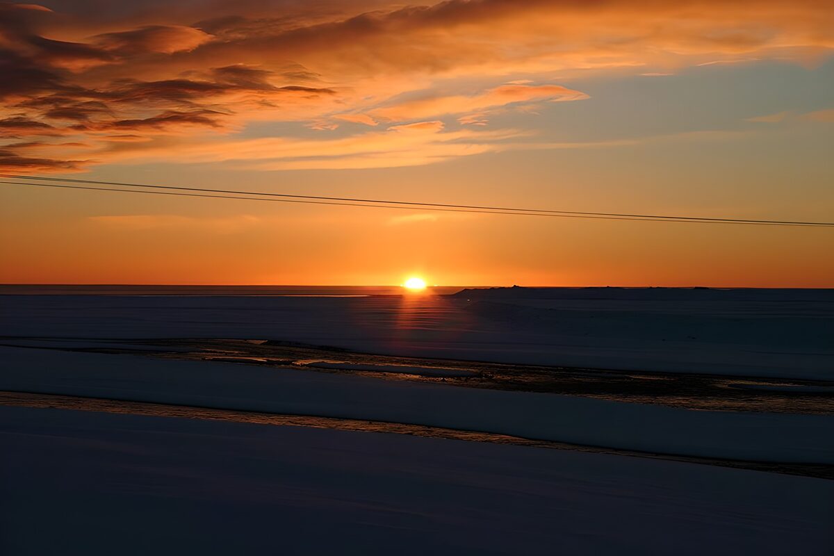 Orange sunset over a shadowed landscape