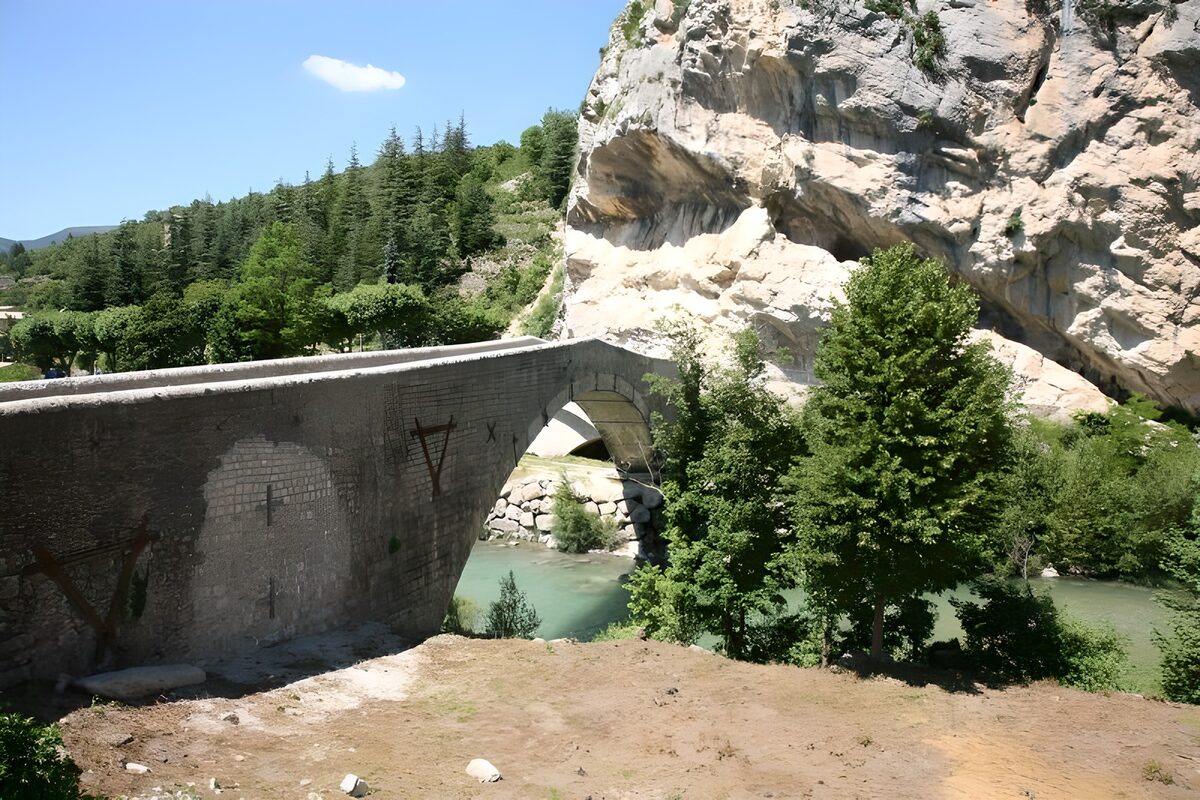 Stone bridge over a pale green river