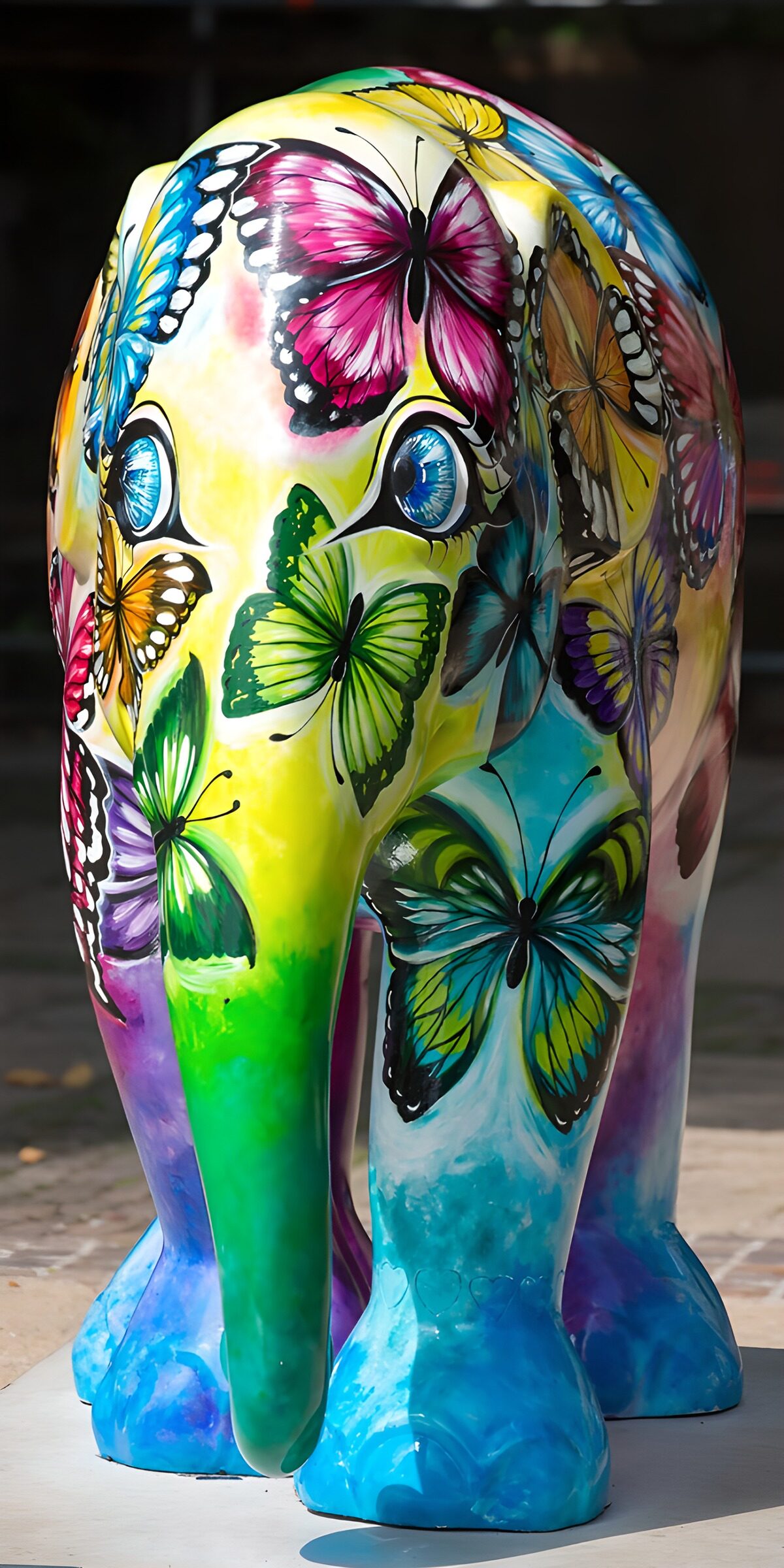 Sunlit elephant sculpture with butterflies