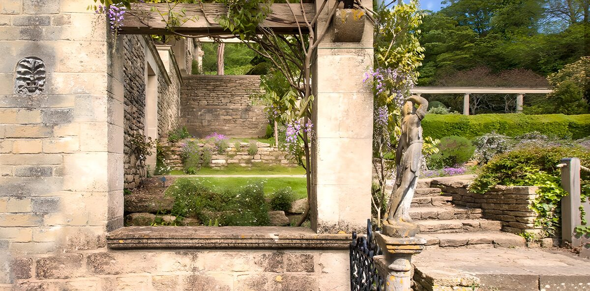 Sunlit pergola and garden statue