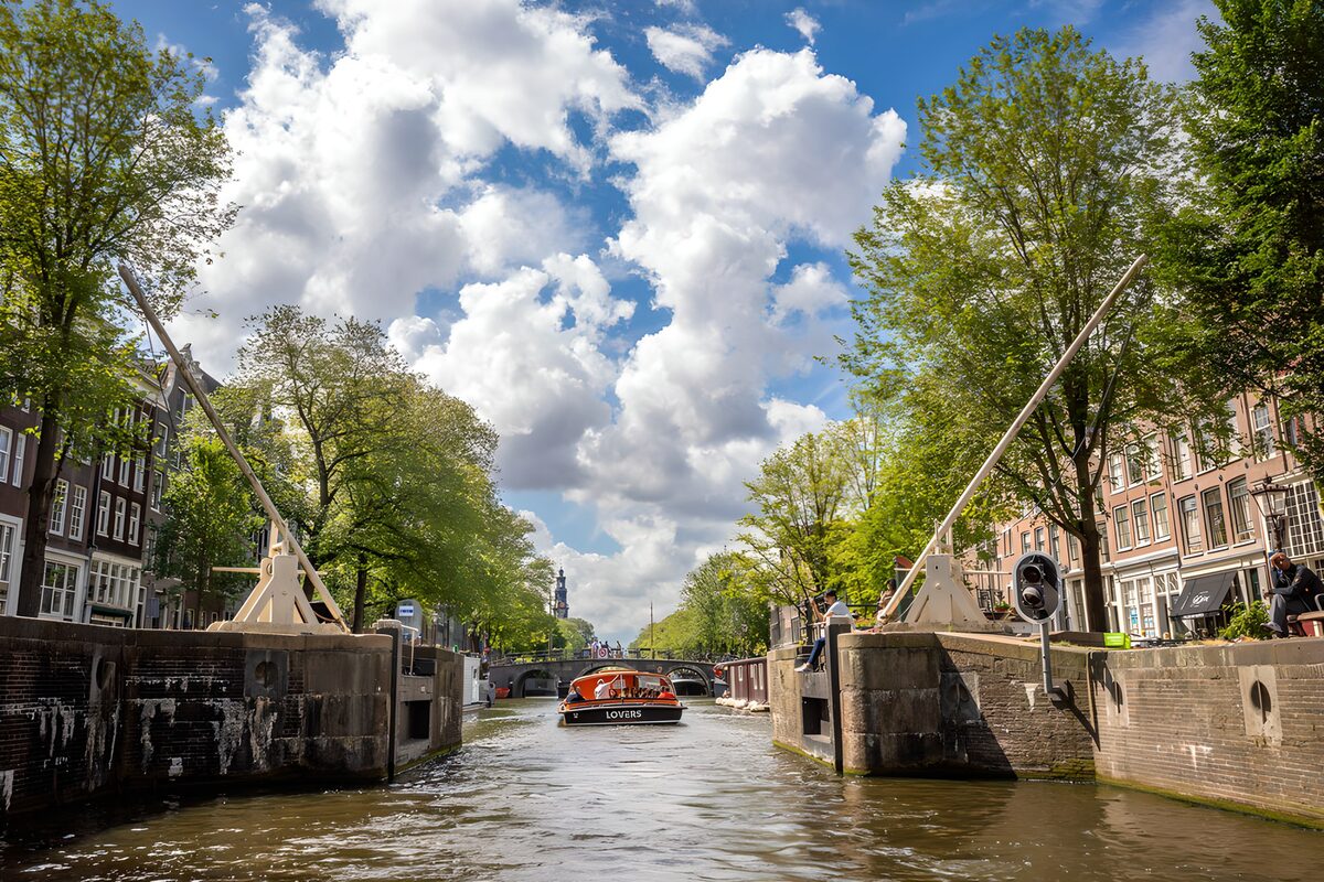Tour boat on a sunlit Amsterdam canal