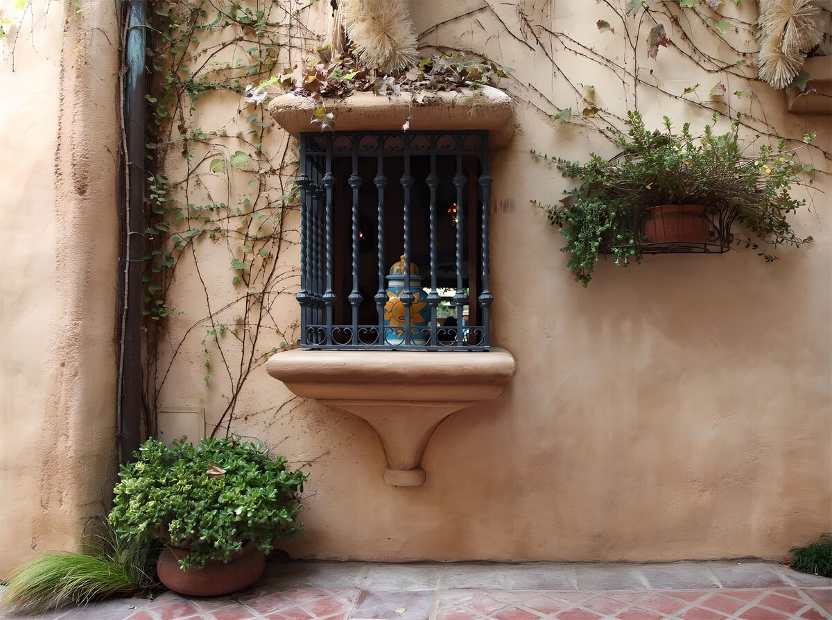Barred window on a warm peach wall