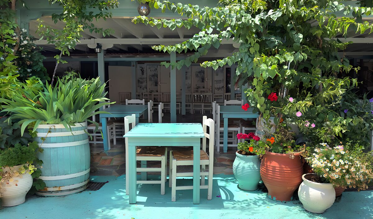 Turquoise tables on a leafy café terrace