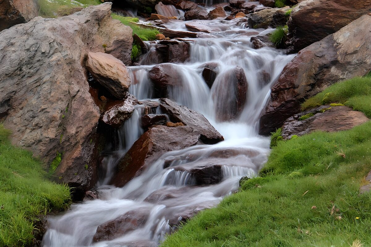 Rocky cascades between fresh green banks