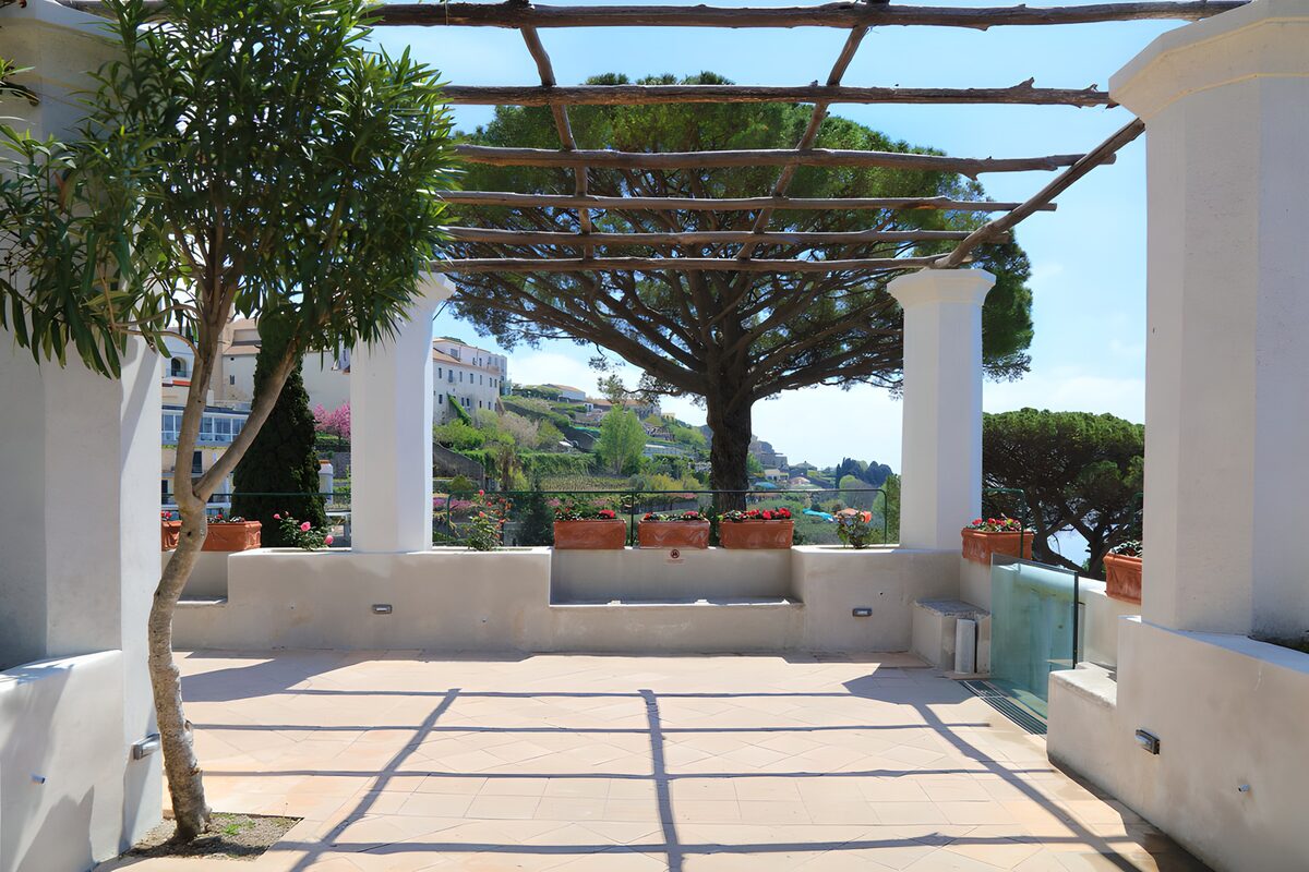 Sunlit terrace beneath a wooden pergola