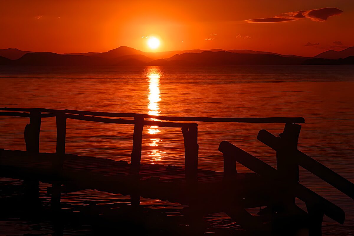 Sunset over water and a silhouetted jetty