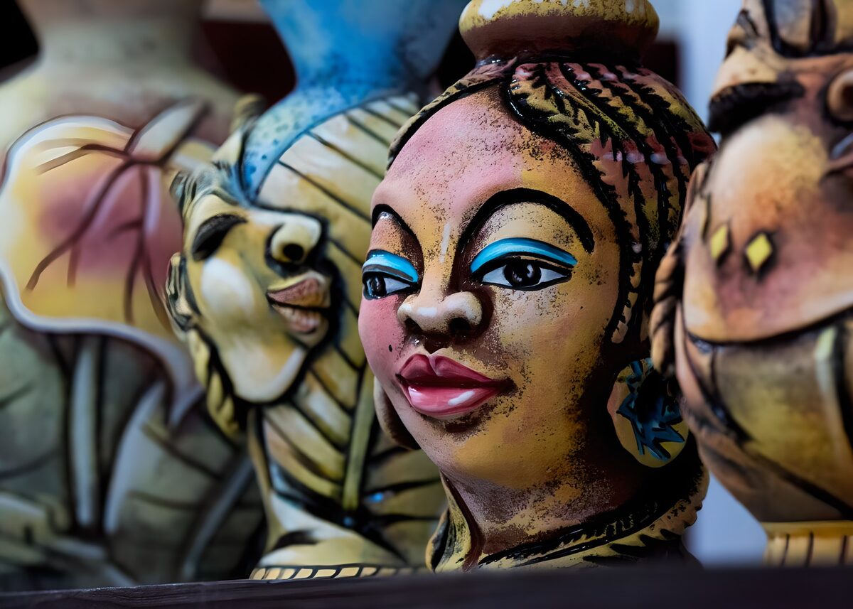 Colourful woman figurine in close company