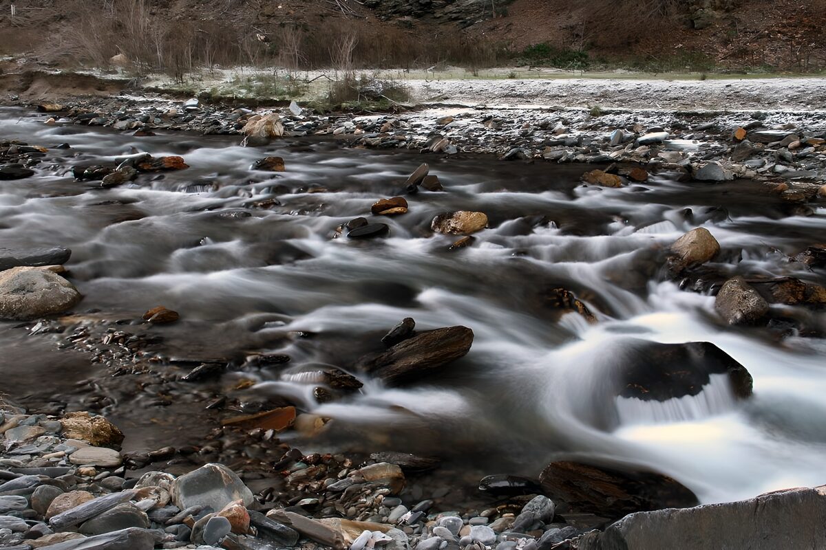 Winter stream over rocks and pebbles