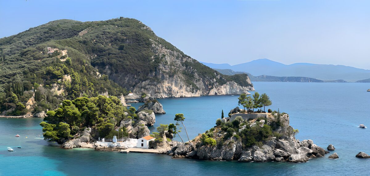White chapel by a sunlit turquoise bay