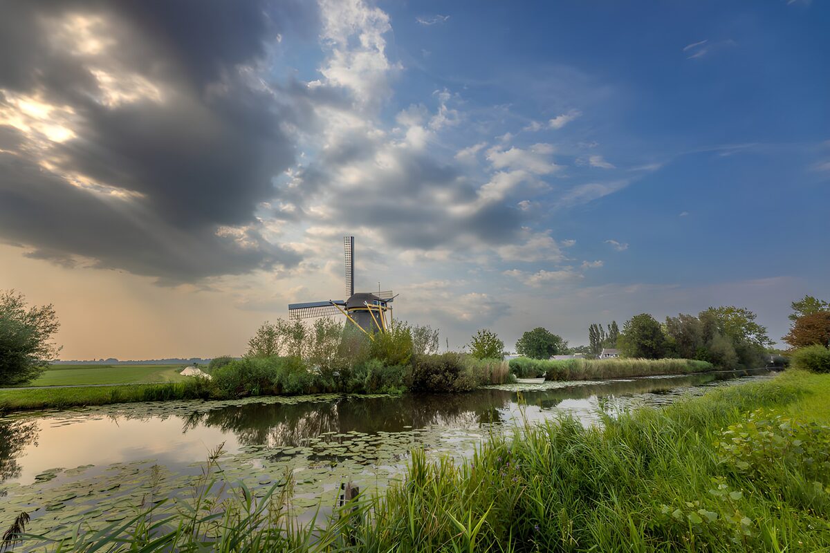 Windmill by the water in evening light