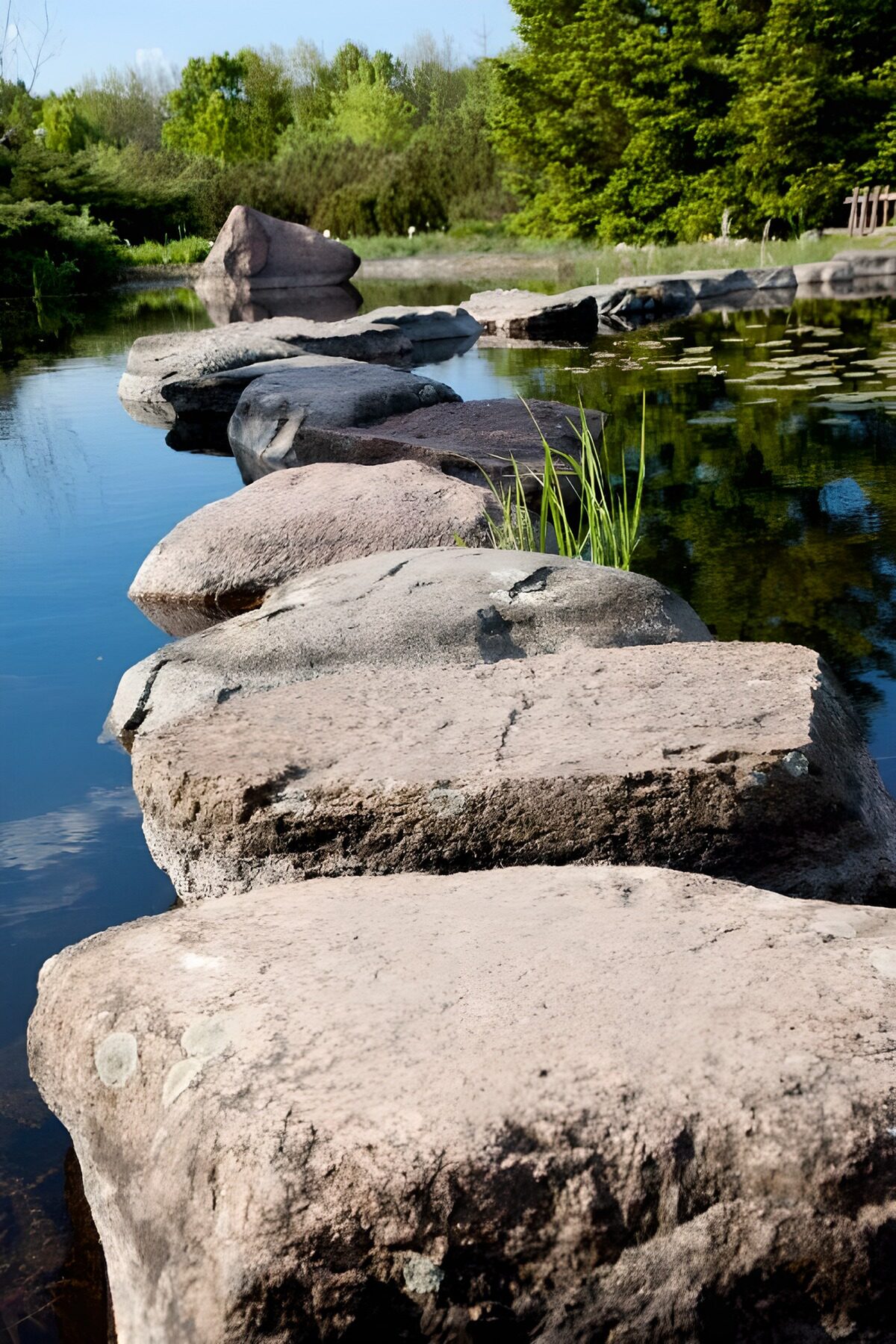 A stone path through sky and reflections