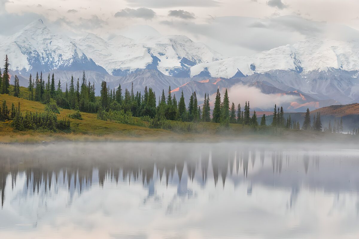 Snowy mountains above a misty lake