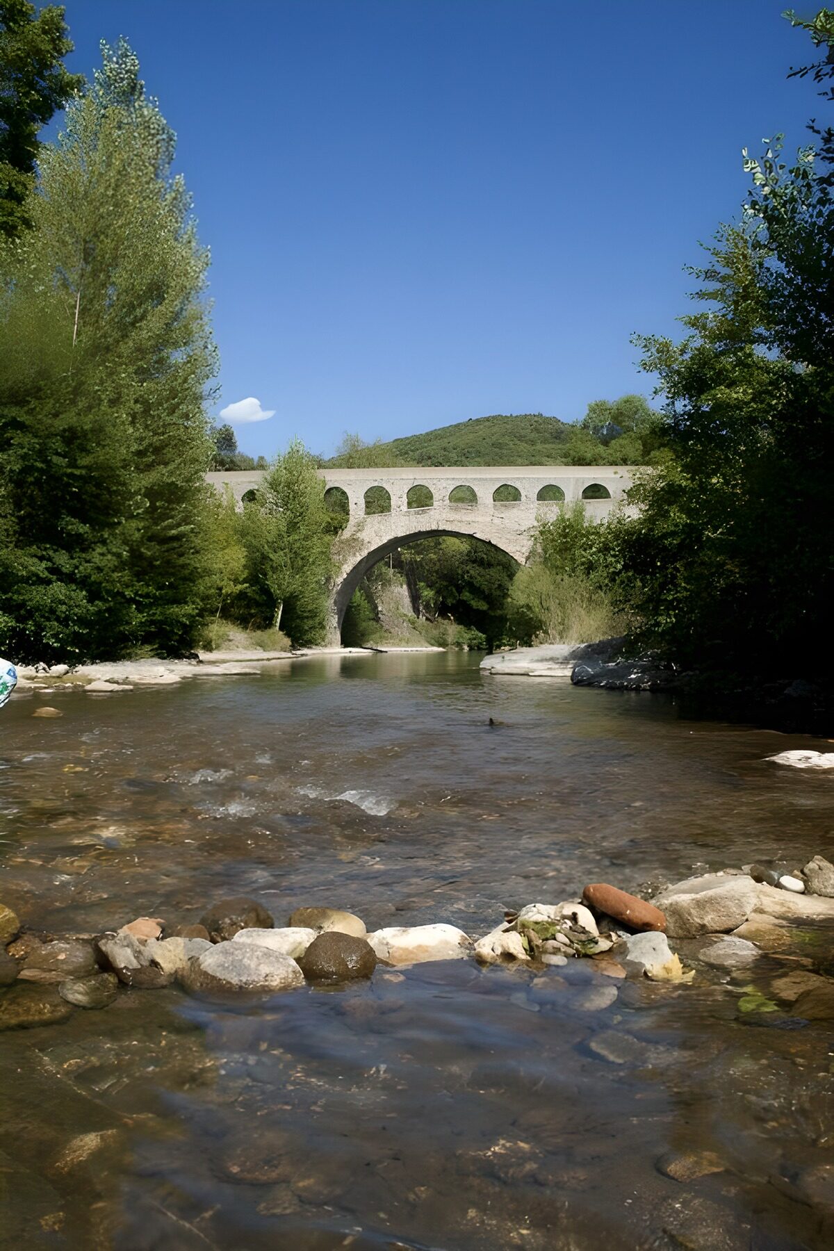 Summer drifts beneath the stone arch