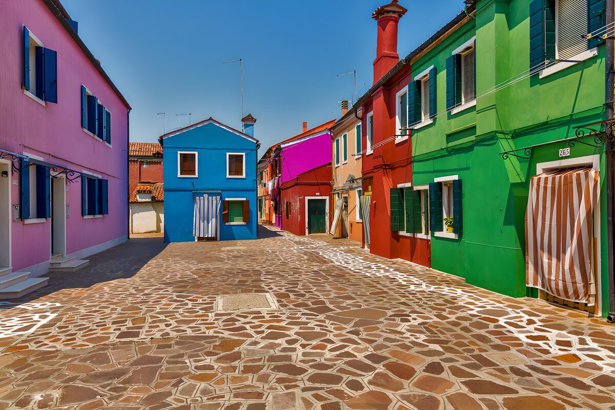 Colourful houses on a sunlit stone street