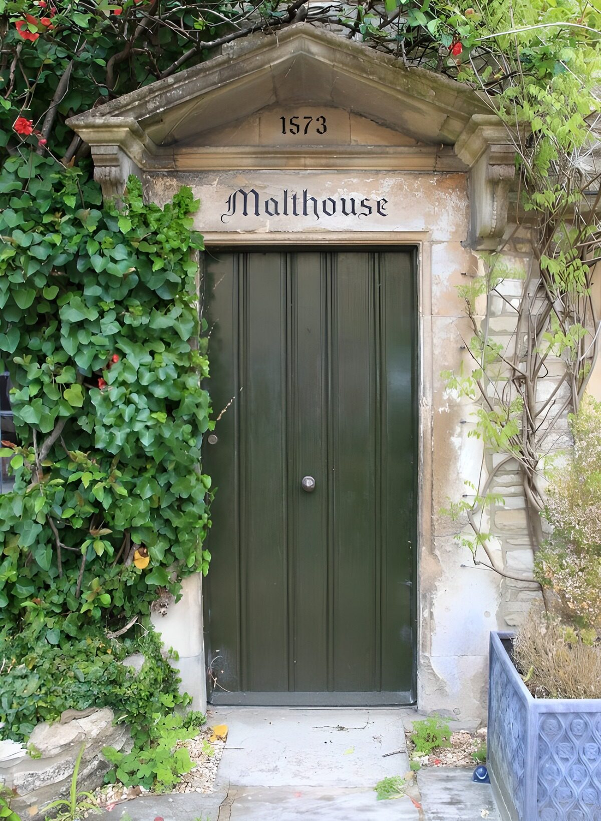 Green door in timeworn stone