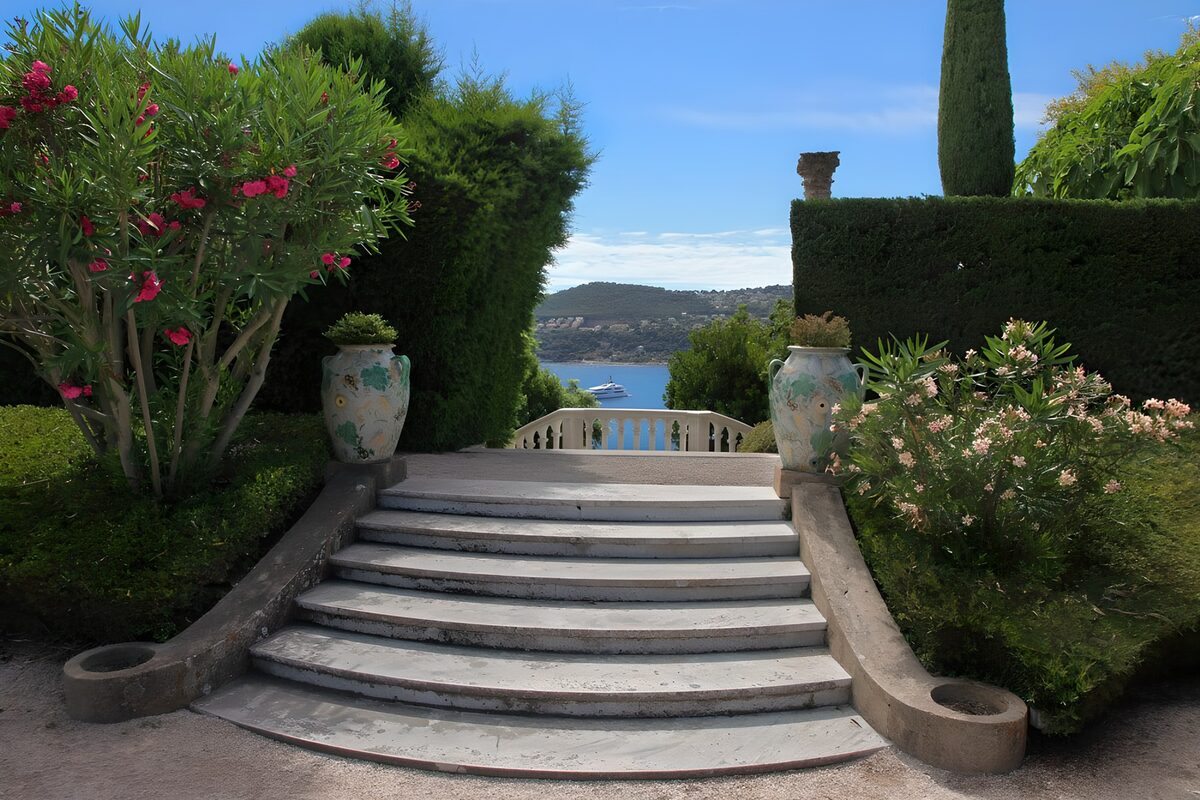 Garden steps overlooking a sunlit bay