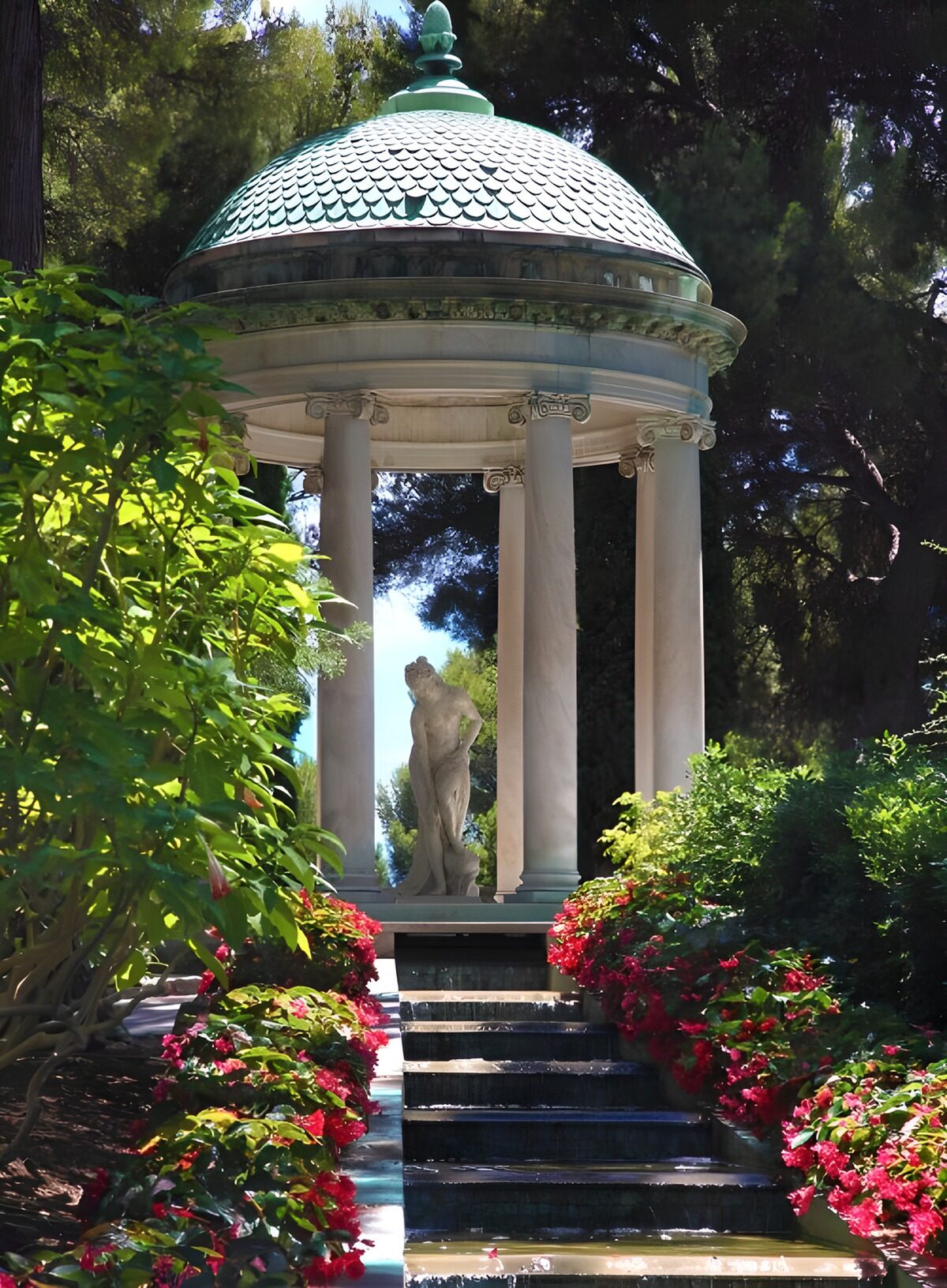 Sunlit pavilion above a garden cascade