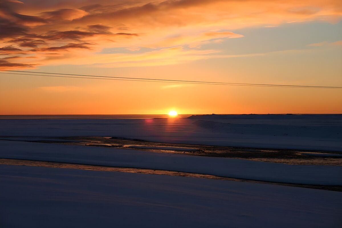 Sunset over a snow-covered plain