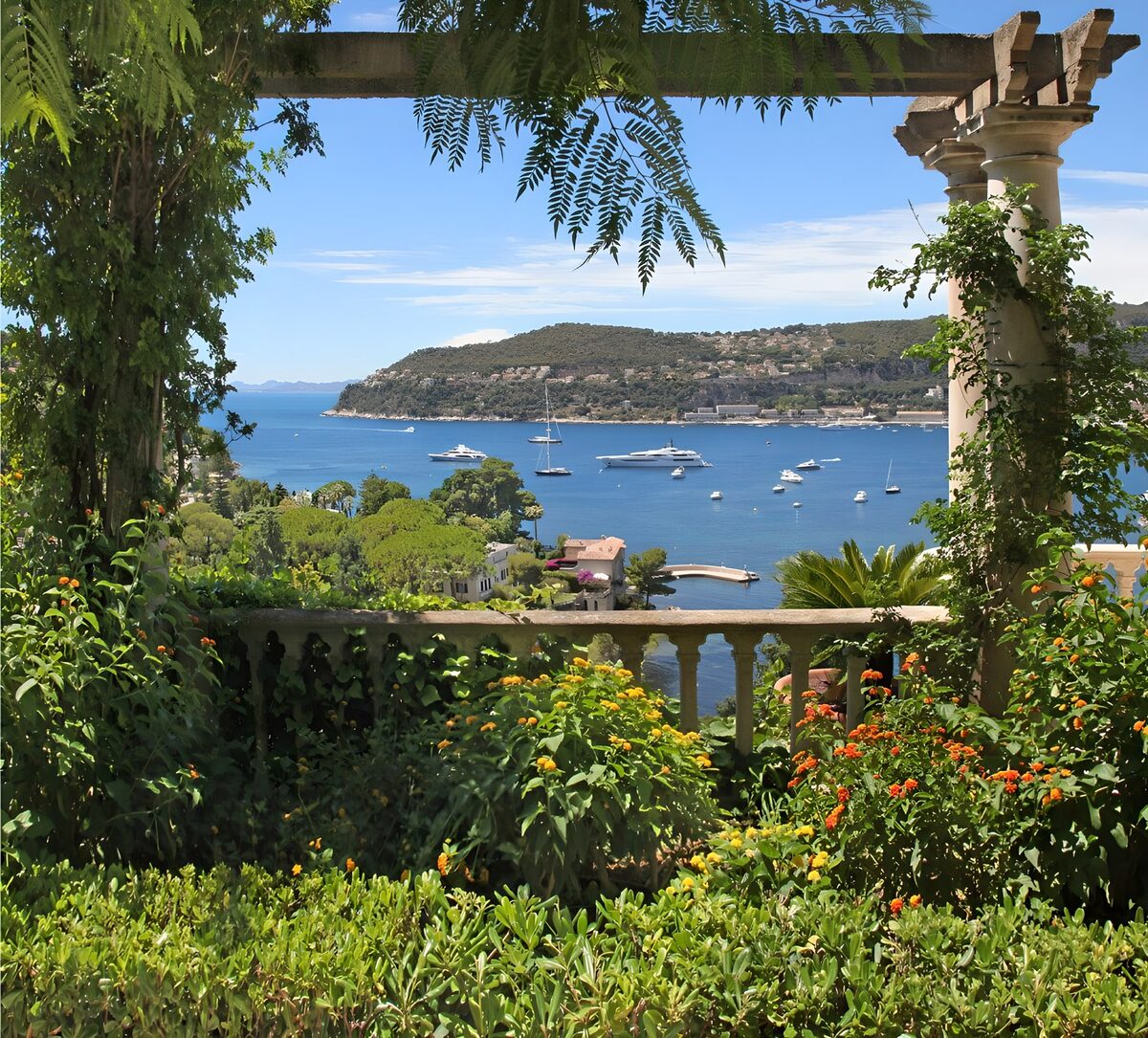 Garden terrace above a sunlit bay