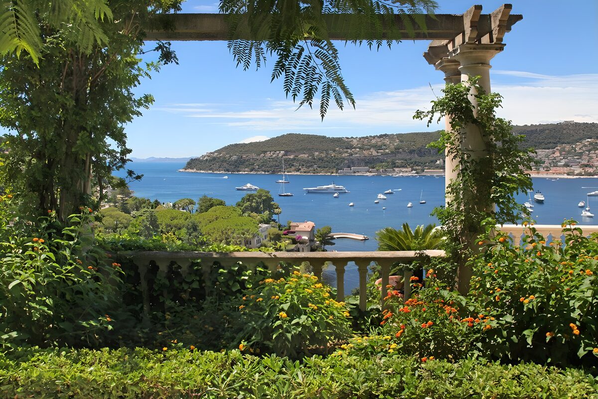 Flower-filled terrace above a blue bay
