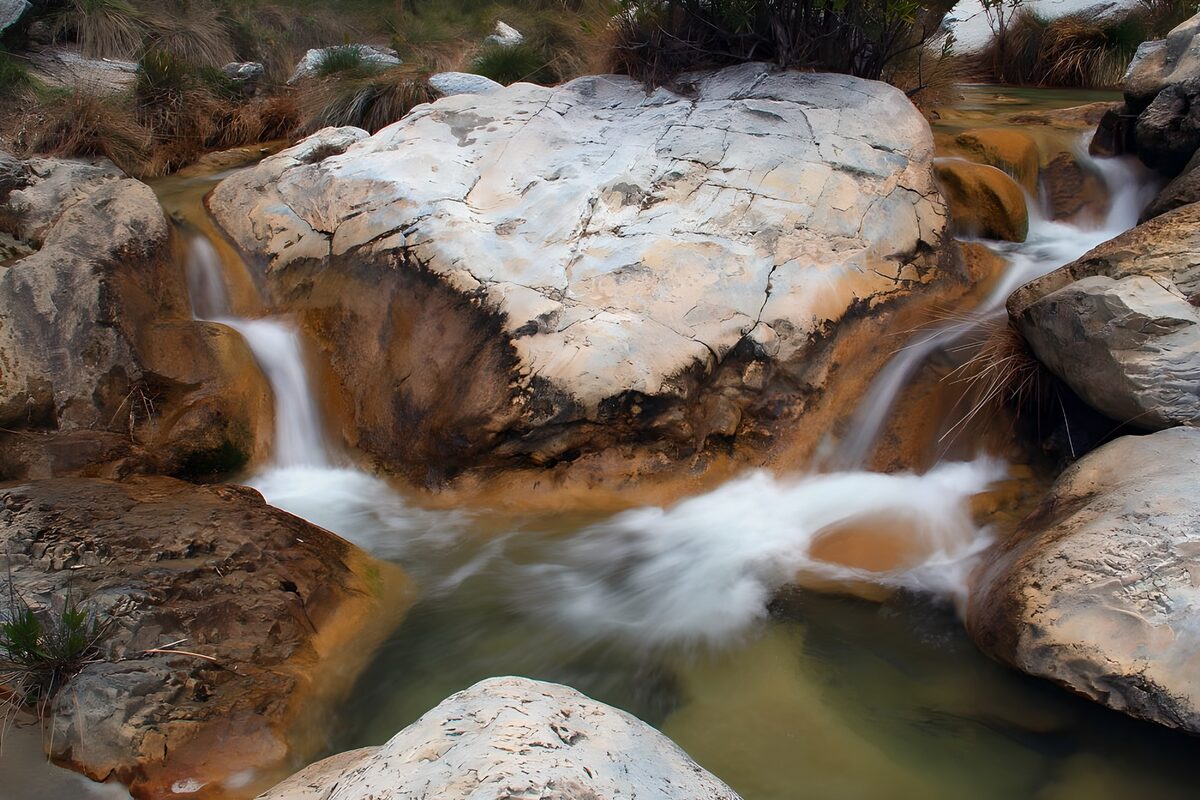 Pale boulder and soft stream cascades
