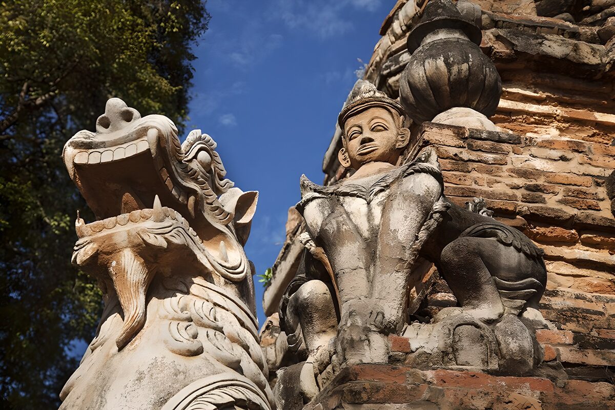 Weathered guardian and seated stone figure