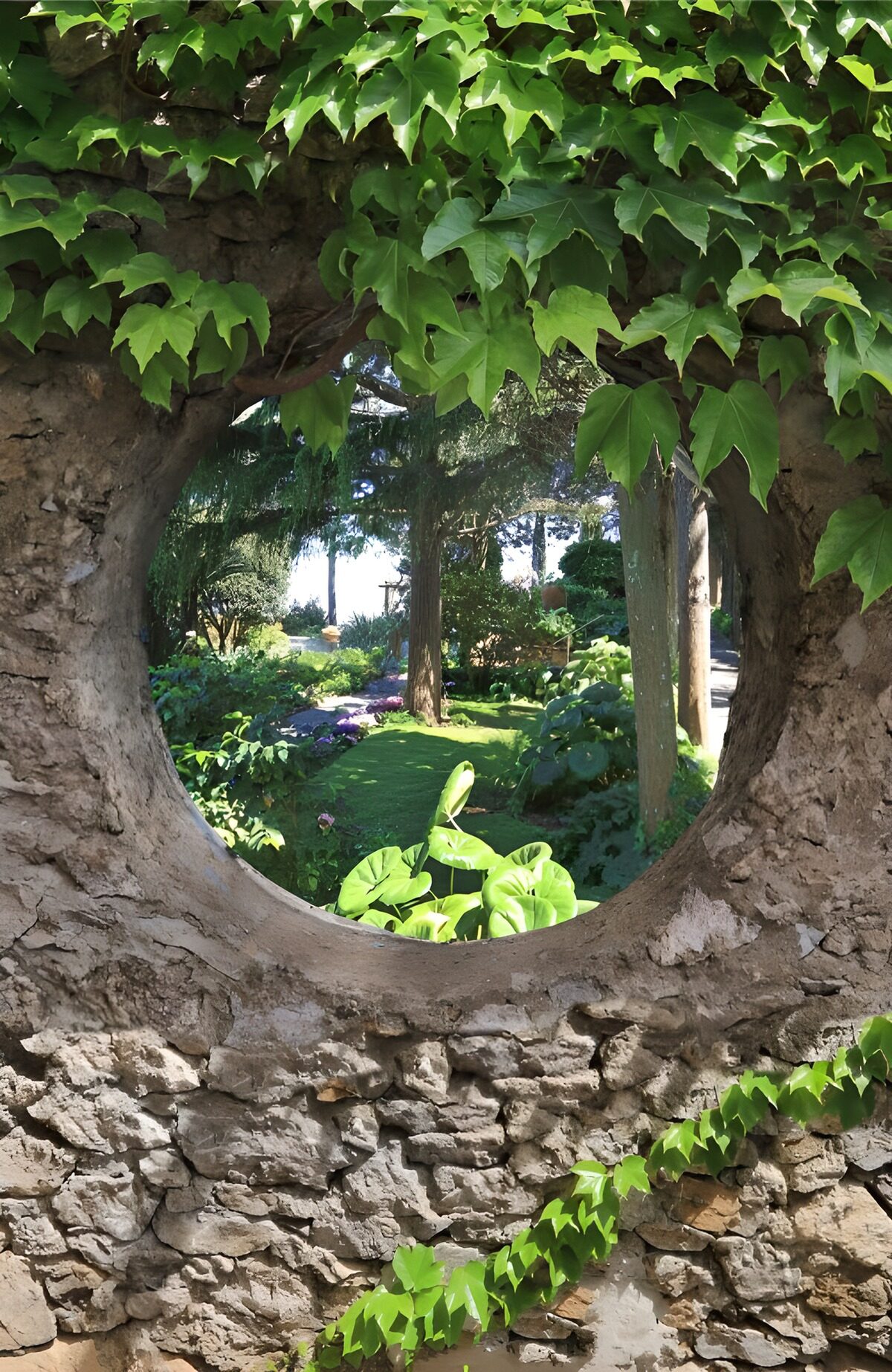 Sunlit garden through a stone wall