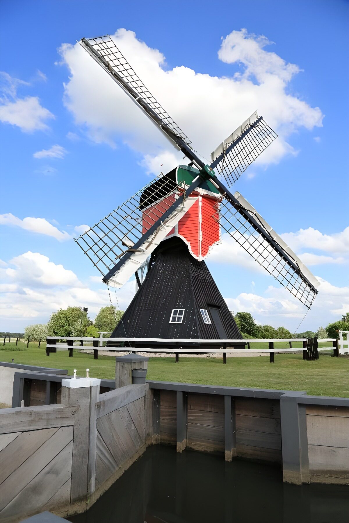Dutch windmill by a sunlit canal
