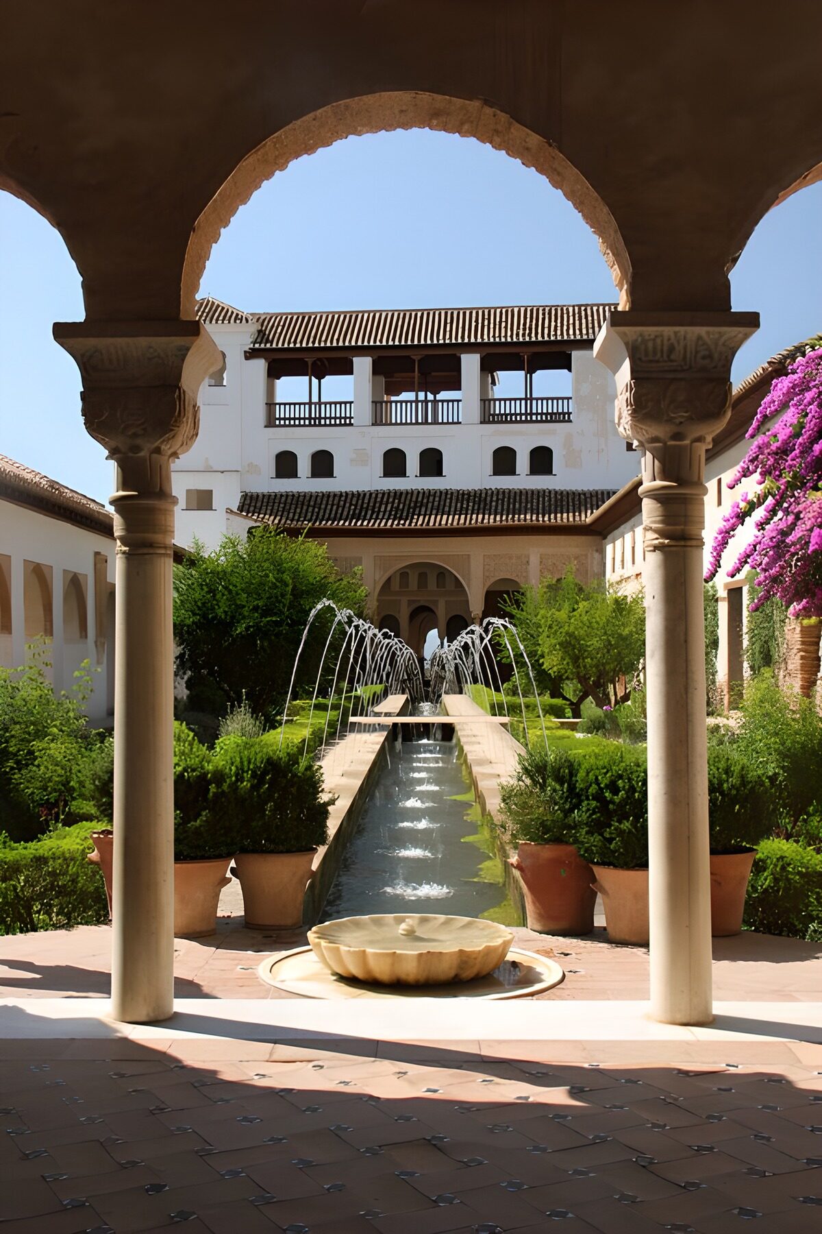Sunlit courtyard through a stone arch