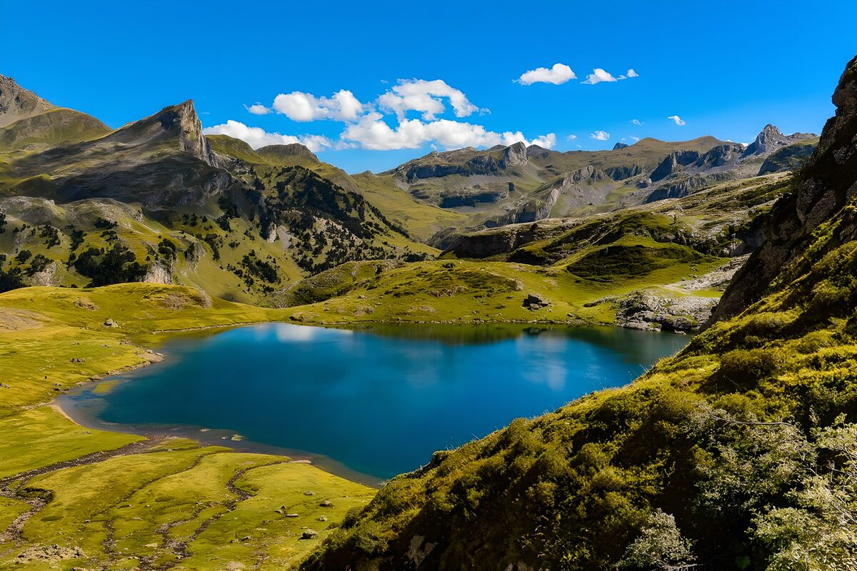 Deep blue lake beneath sunlit peaks
