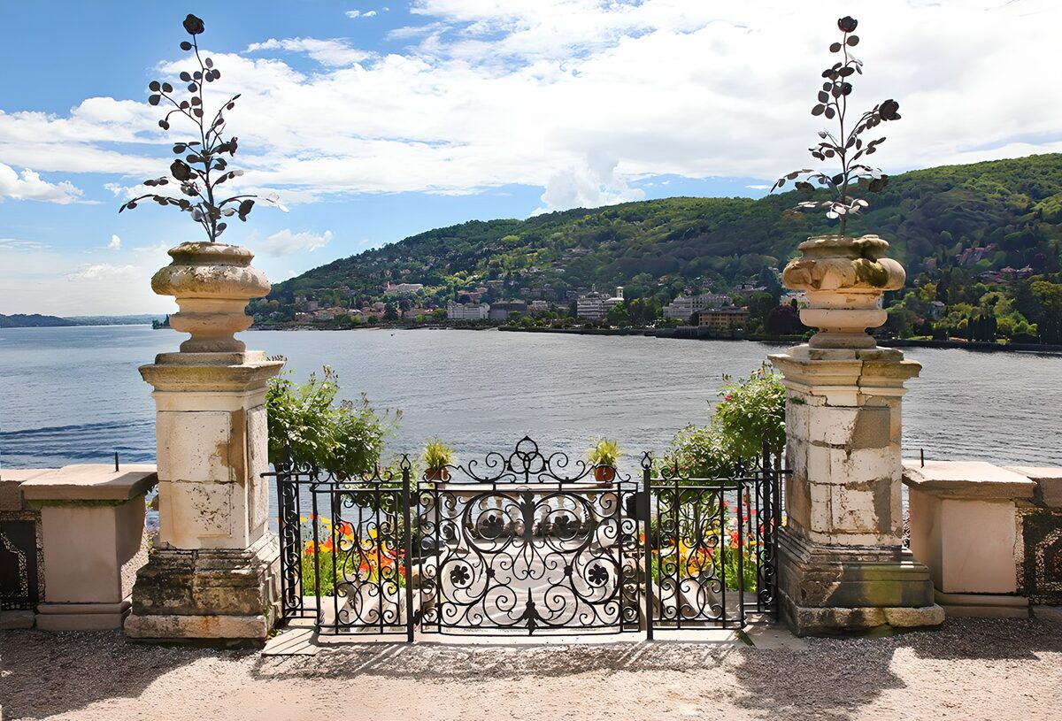 Wrought-iron gate above a sunlit lake