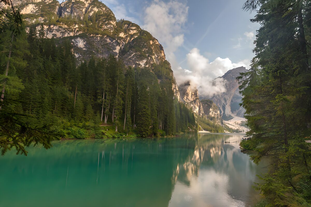 Turquoise lake beneath pale mountain cliffs