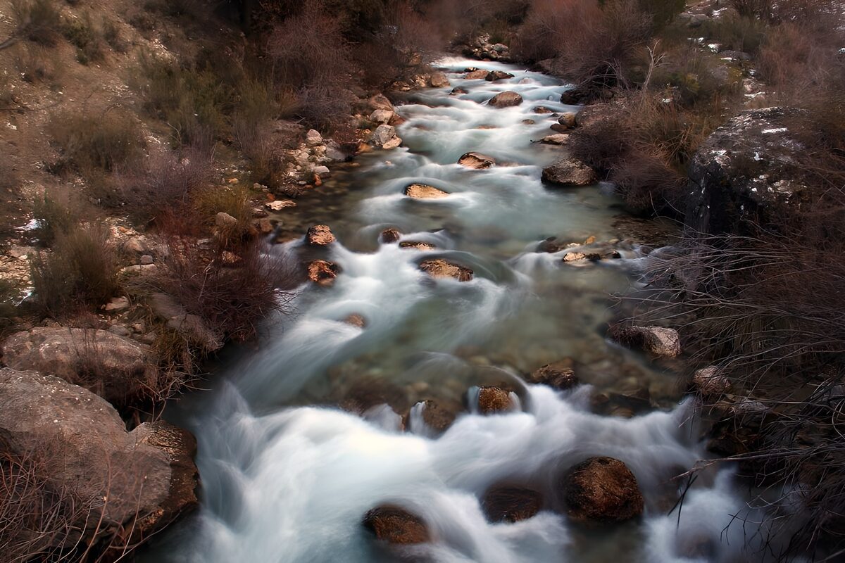 Fast-flowing stream over rounded rocks