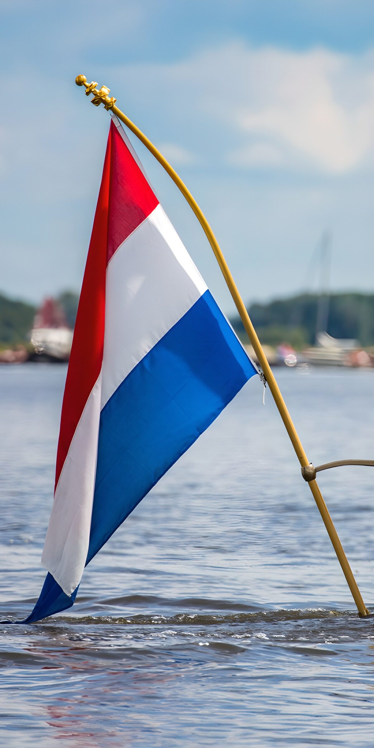 Dutch flag over sunlit water