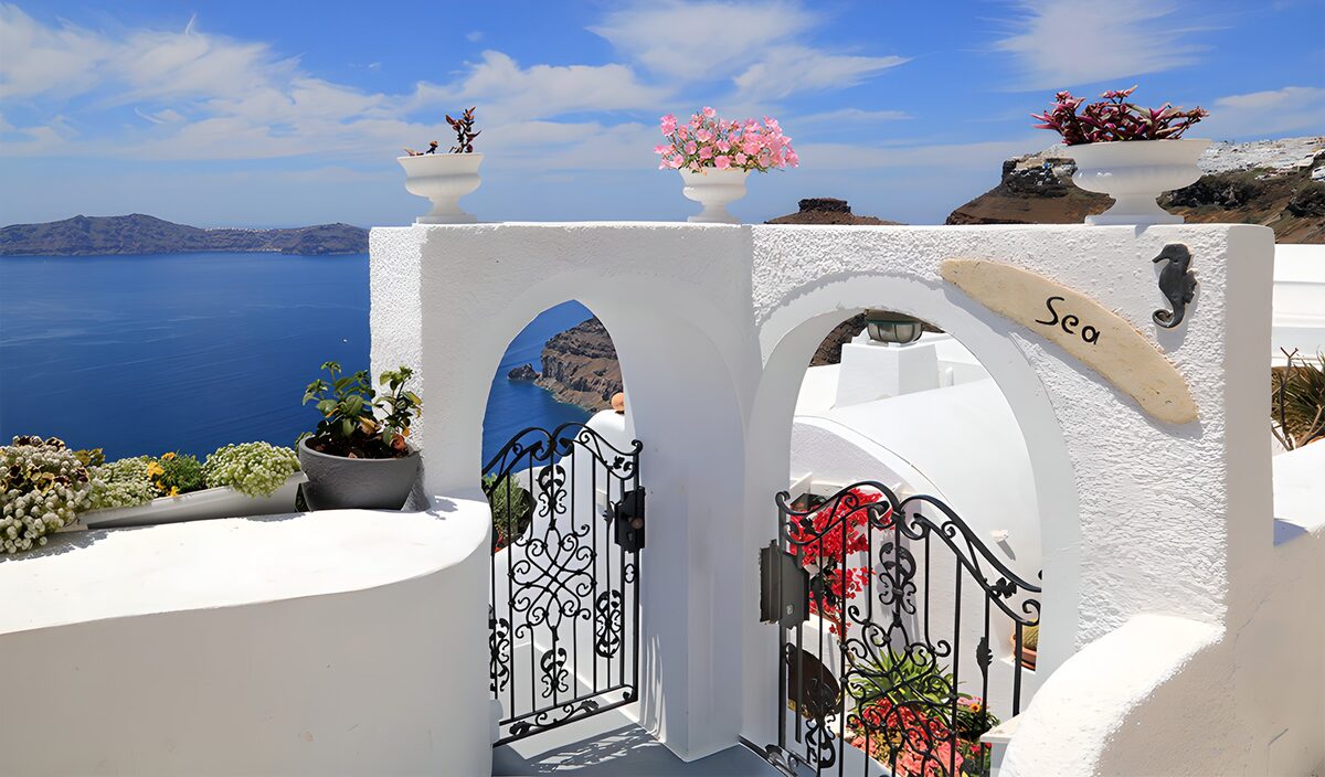 Sunlit white arches above the blue sea