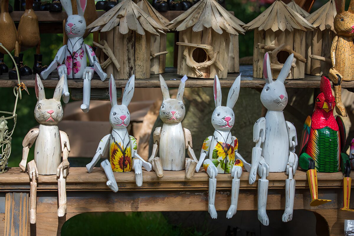 Painted wooden rabbits on rustic shelves