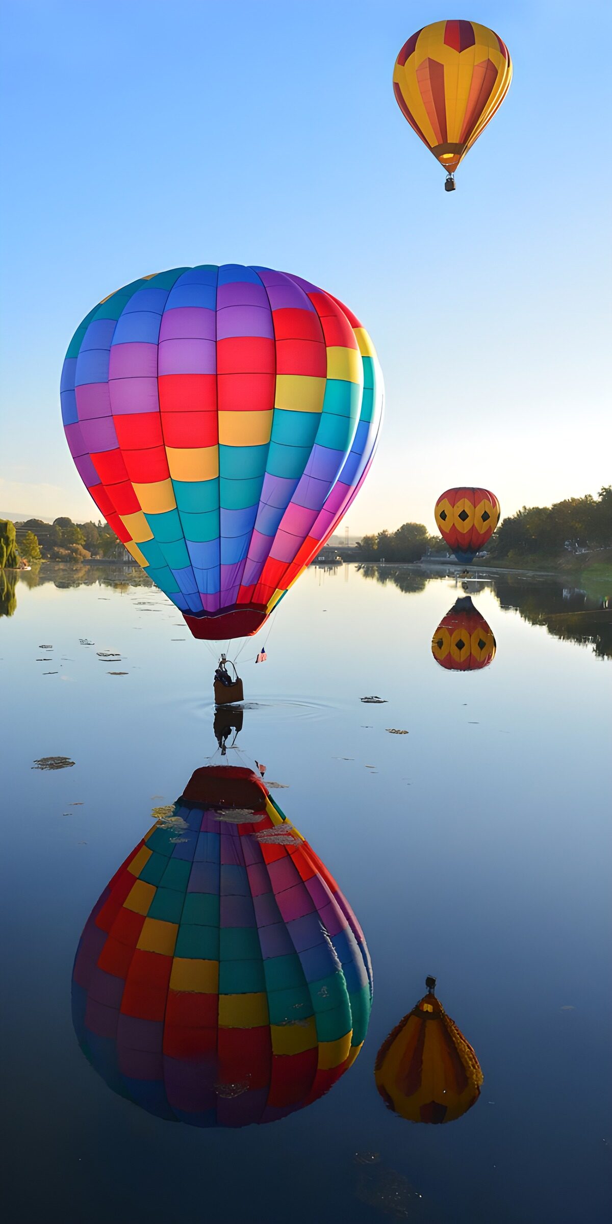 Colourful balloons over a glassy lake