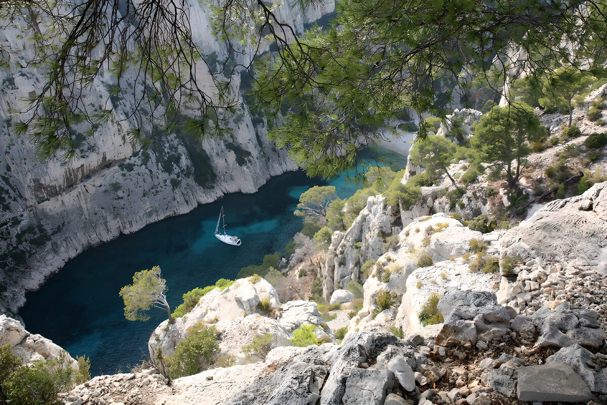 Yacht in a quiet, cliff-lined cove